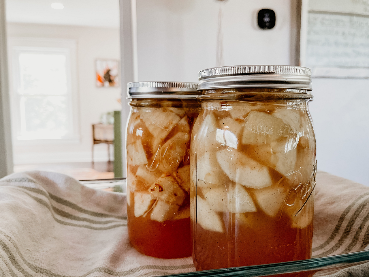 Image of apples in canning jars ready to be stored.