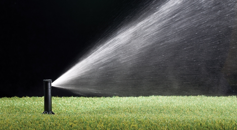 Automatic sprinkler system delivers water to grass at night time