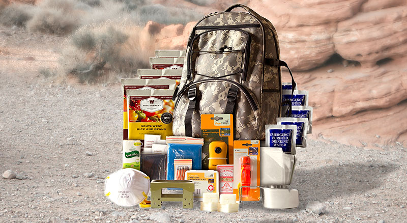 Large backpack in the center of various essential safety and first-aid supplies
