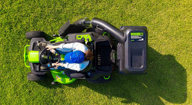 Aerial view of person cutting grass using riding lawn mower