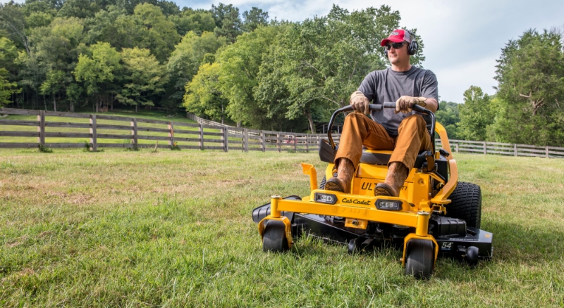 Rancher mows grass using yellow Cub Cadet zero-turn lawn mower