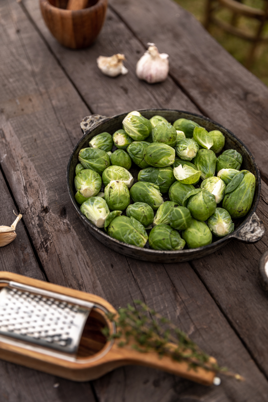 Image of Brussels sprouts in a bowl, on a table.